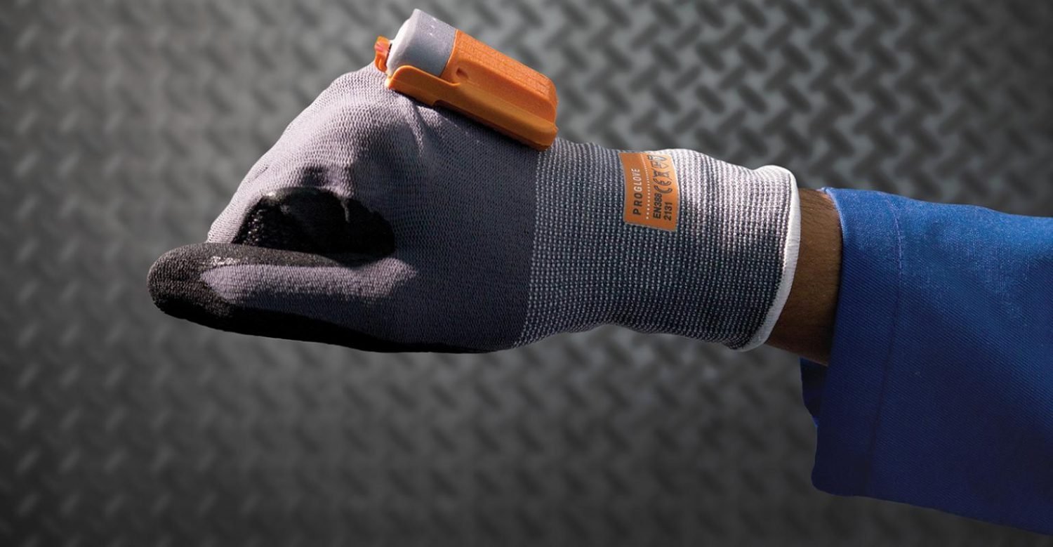 Person modeling glove with hi-tech device attached.