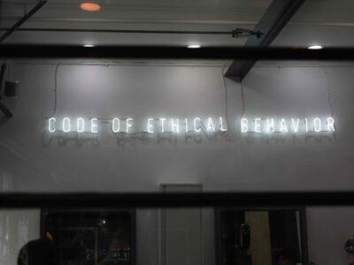 Neon sign with words, "Code of Ethical Behavior."