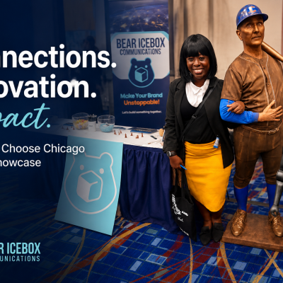 A woman stands smiling between a baseball player statue and a robot, in front of a Bear Icebox Communications booth at the Choose Chicago Partner Showcase. Bold text highlights “Connections. Innovation. Impact.”.